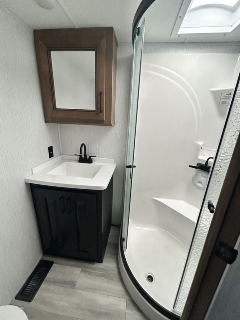 Bathroom with a sink and a walk-in shower.