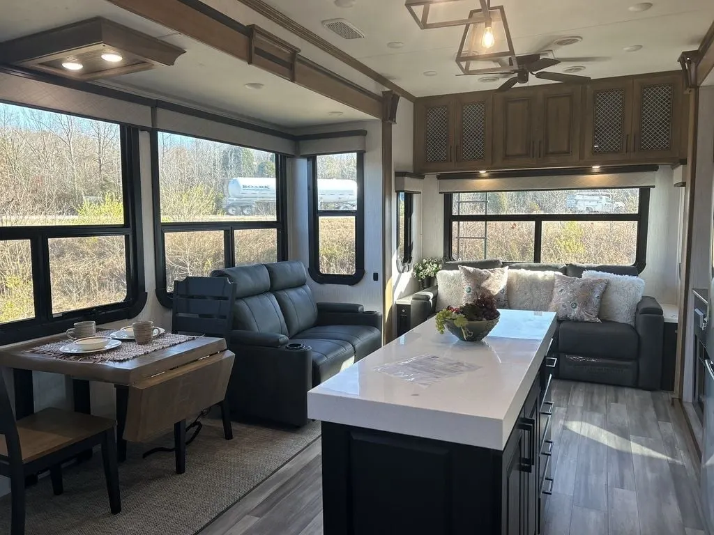 Interior view of the RV with a dinette and a living space.