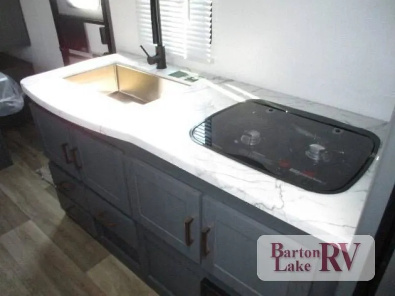 Kitchen with a sink and a gas range.