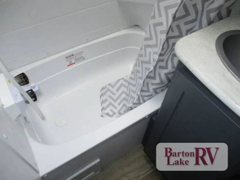 Bathroom with a sink and a shower.