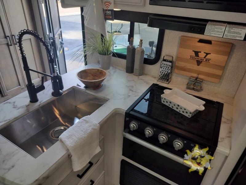 Kitchen with a sink and a gas range.