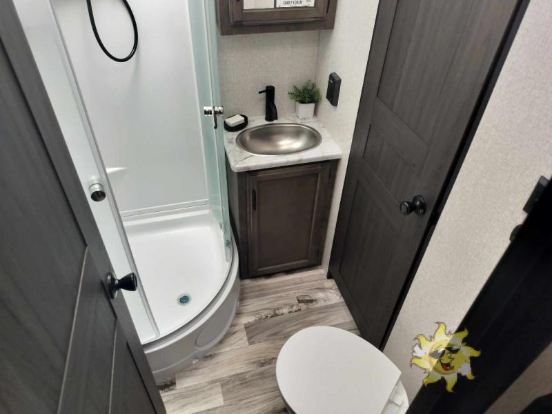 Bathroom with a sink, toilet and a walk-in shower.