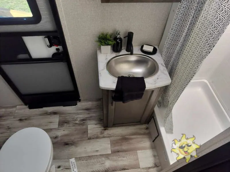 Bathroom with a sink, toilet and a walk-in shower.