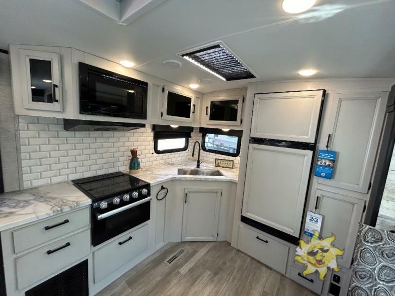 Kitchen with a gas burner, fridge, oven, sink and cabinets.