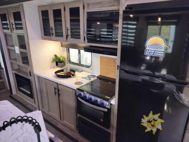 Kitchen with a gas range, fridge, oven, sink and cabinets.