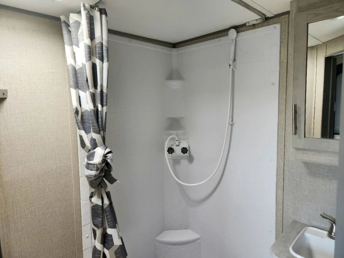 Bathroom with a sink and a shower.