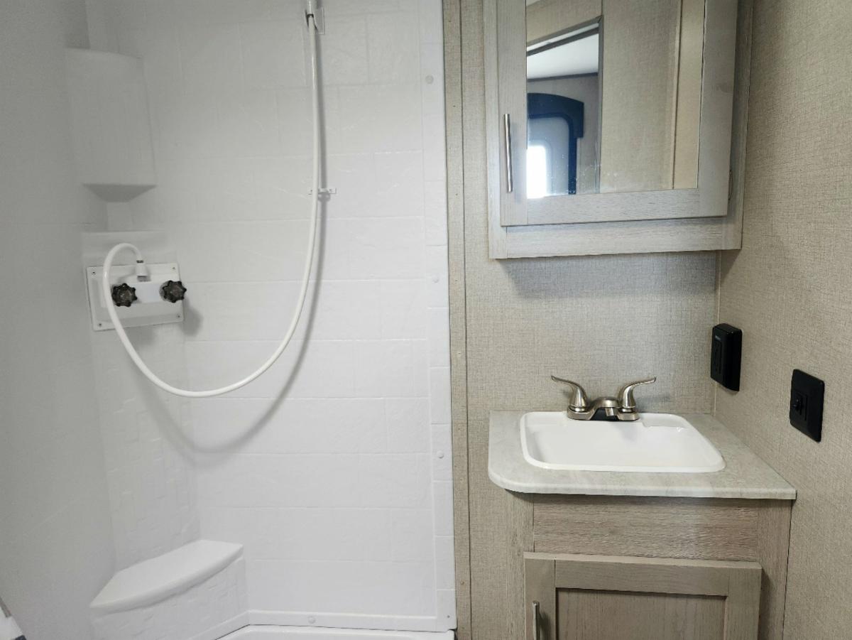 Bathroom with a sink and a shower.