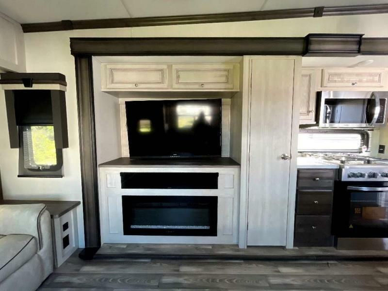 Entertainment center with a TV and a fireplace.