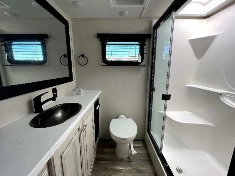 Bathroom with a sink, toilet and a walk-in shower.