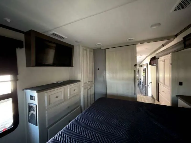 Bedroom with a king size bed and a dresser.