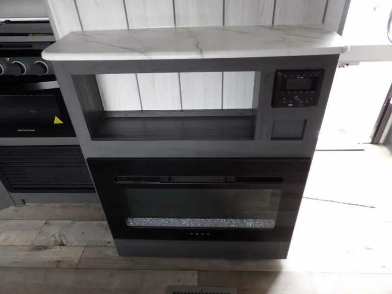 Entertainment center with a fireplace.