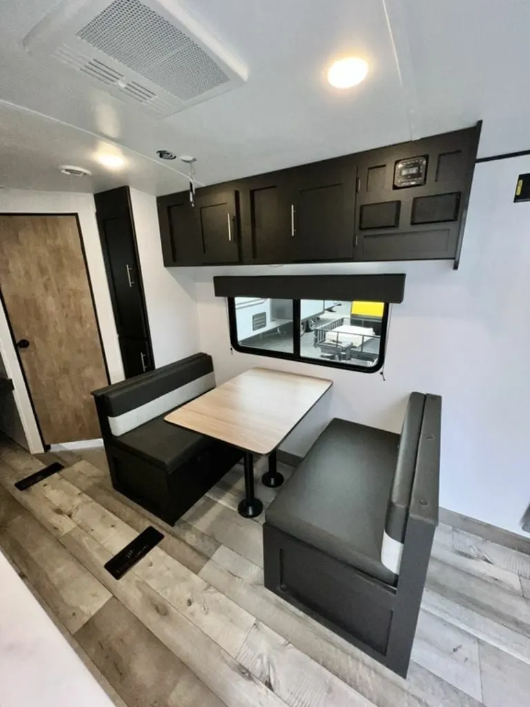 Dinette with overhead cabinets.