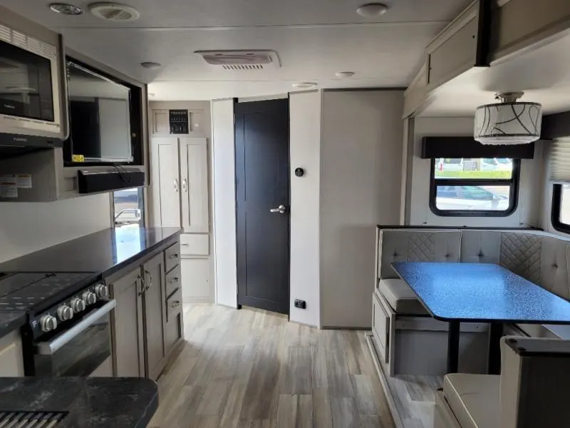 Interior view of the RV with a dinette and a kitchen.