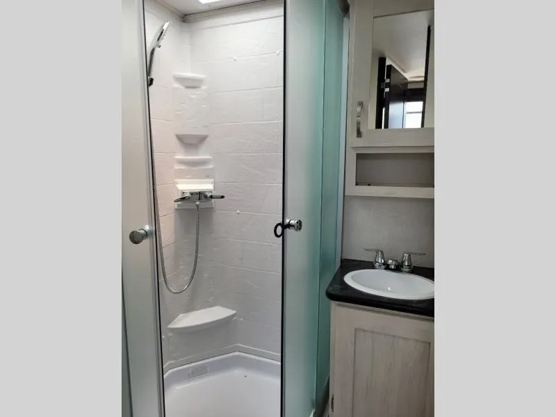 Bathroom with a sink and a walk-in shower.