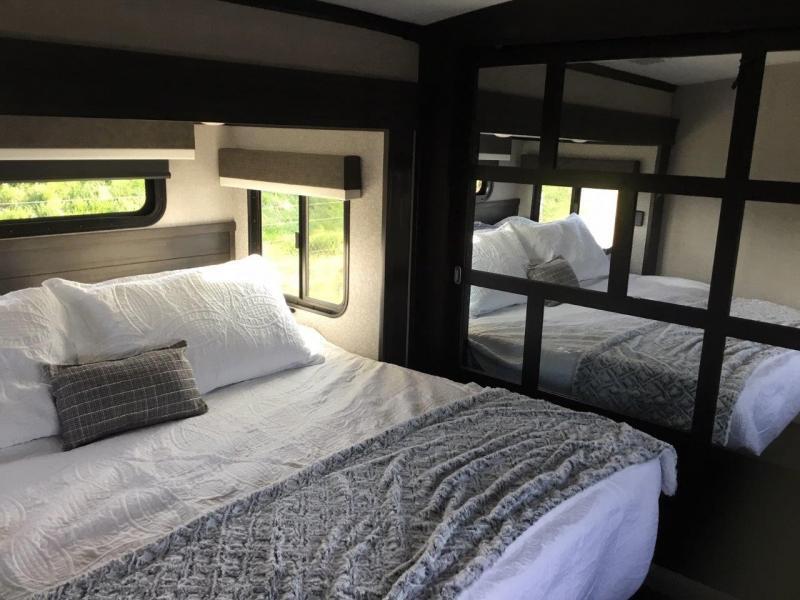 Bedroom with a queen size bed and a closet.