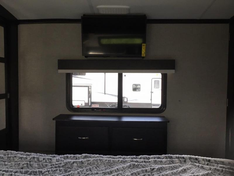 Bedroom with a TV and a dresser.