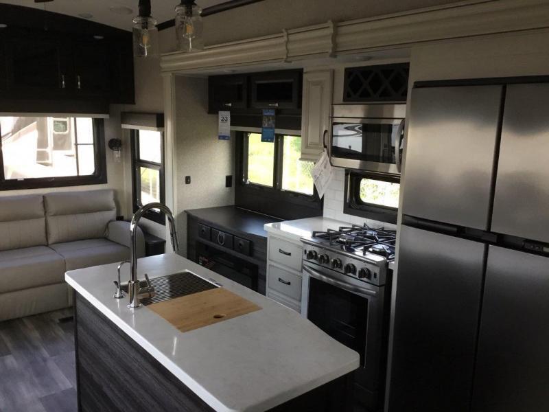 Kitchen with a gas range, fridge, oven, sink and cabinets.