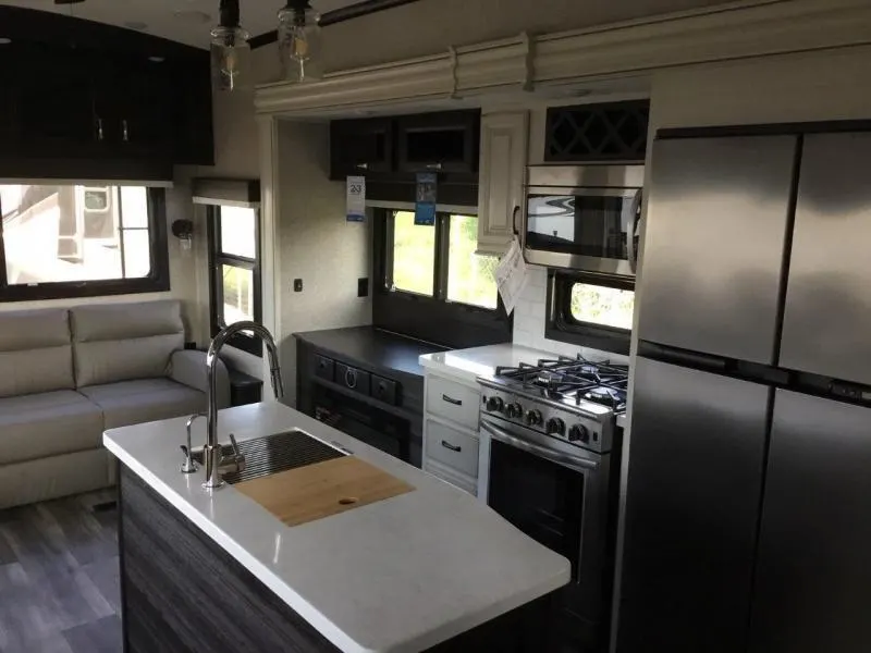 Kitchen with a gas range, fridge, oven, sink and cabinets.