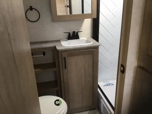 Bathroom with a sink, toilet and a medicine cabinet.