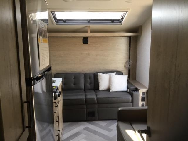 Interior view of the RV with a living space and a kitchen.