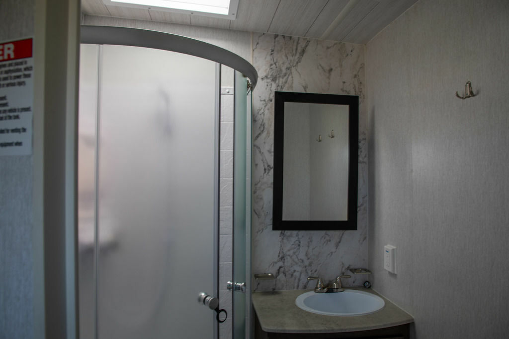 Bathroom with a sink and a walk-in shower.