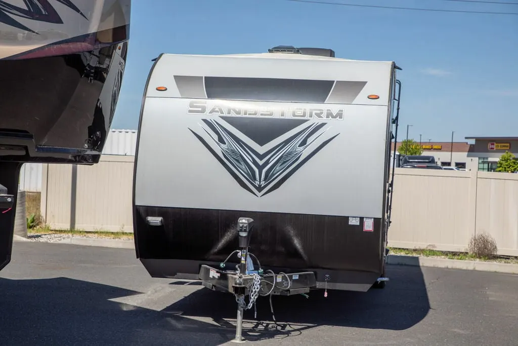 Front view of the New 2022 Forest River Travel Trailer Sandstorm SLC Series 242GSLC Toy Hauler RV.