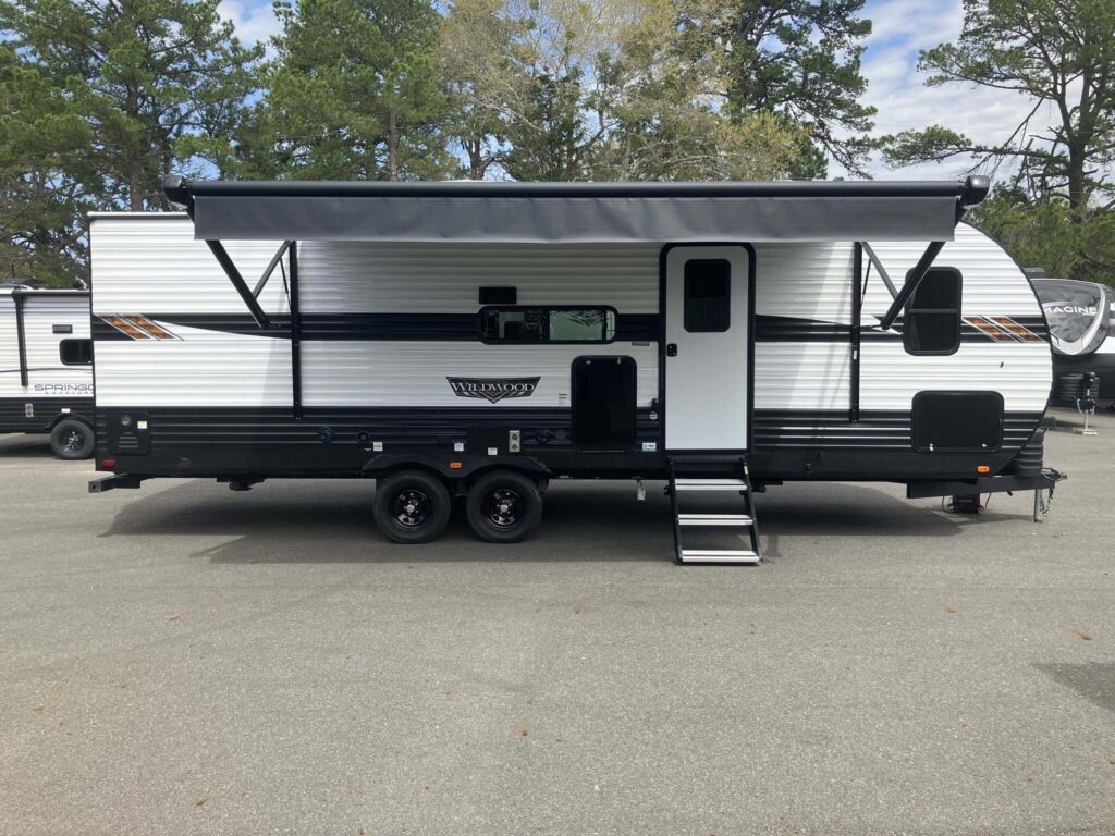 Side view of the RV with an awning.