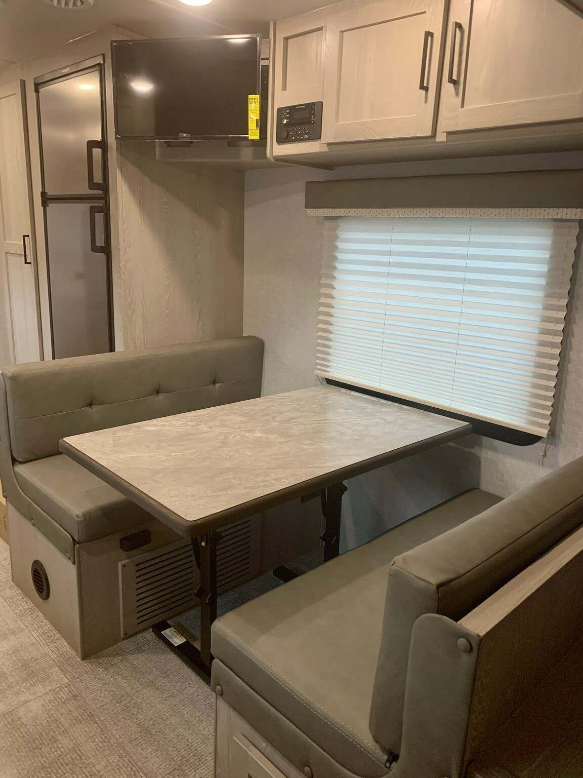 Dinette with overhead cabinets.