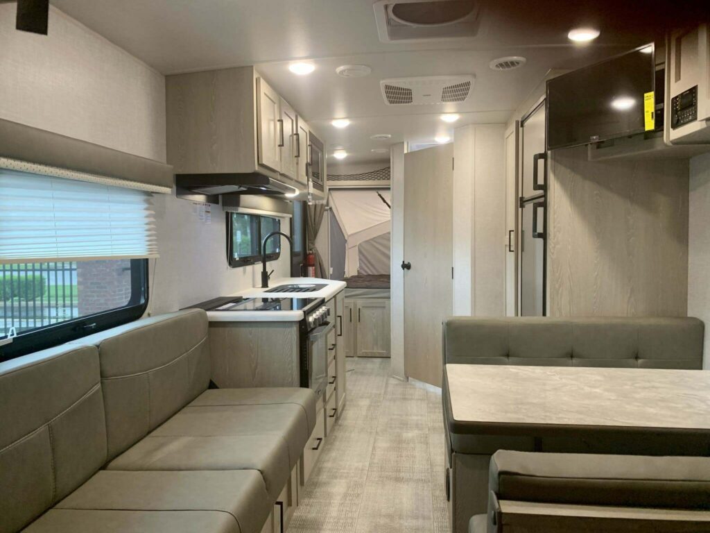 Interior view of the RV with a dinette, living space and a kitchen.