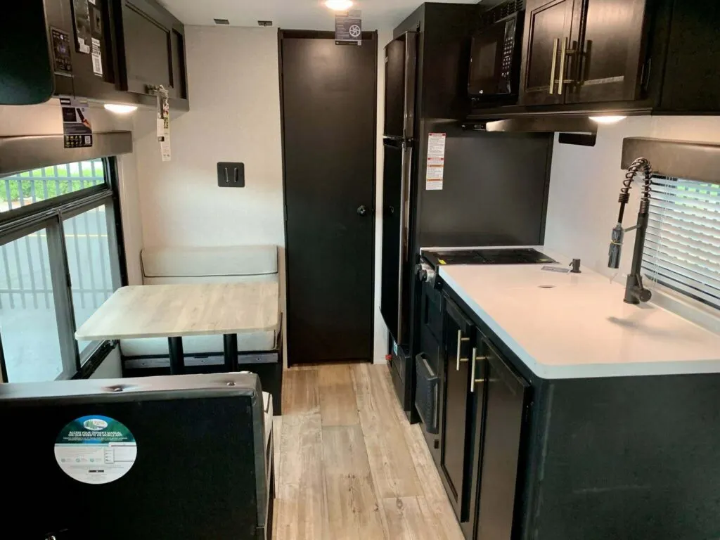 Interior view of the RV with a dinette and a kitchen.