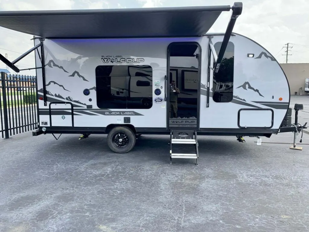 Side view of the New 2022 Forest River Cherokee Wolf Pup 16FQ Black Label Travel Trailer RV.