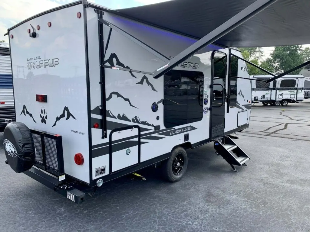 Side view of the New 2022 Forest River Cherokee Wolf Pup 16FQ Black Label Travel Trailer RV.