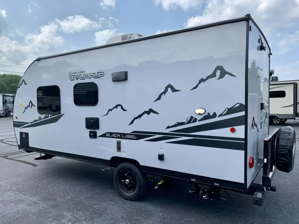 Side view of the New 2022 Forest River Cherokee Wolf Pup 16FQ Black Label Travel Trailer RV.