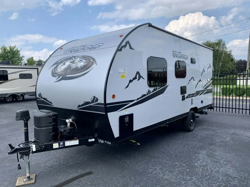 Side view of the New 2022 Forest River Cherokee Wolf Pup 16FQ Black Label Travel Trailer RV.