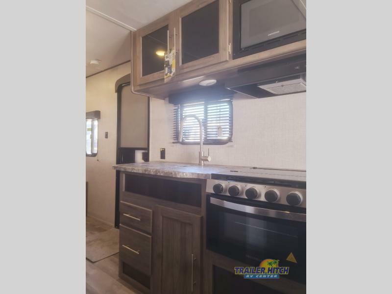 Kitchen with a gas range, oven, sink and cabinets.