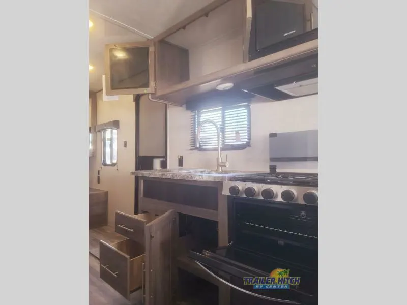 Kitchen with a gas range, oven, sink and cabinets.