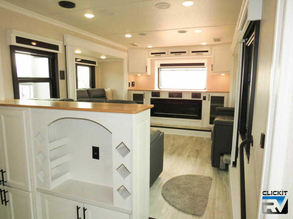 Living space with theater seats, TV, fireplace and reclining chairs.