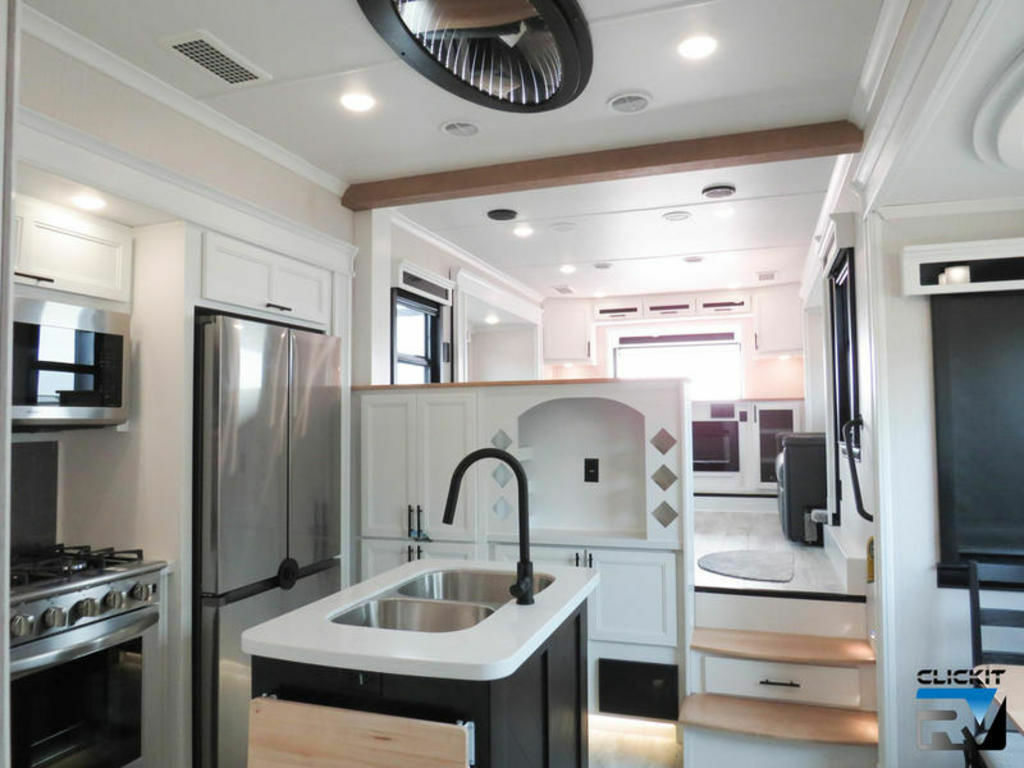 Kitchen with a gas burner, fridge, oven, sink and cabinets.