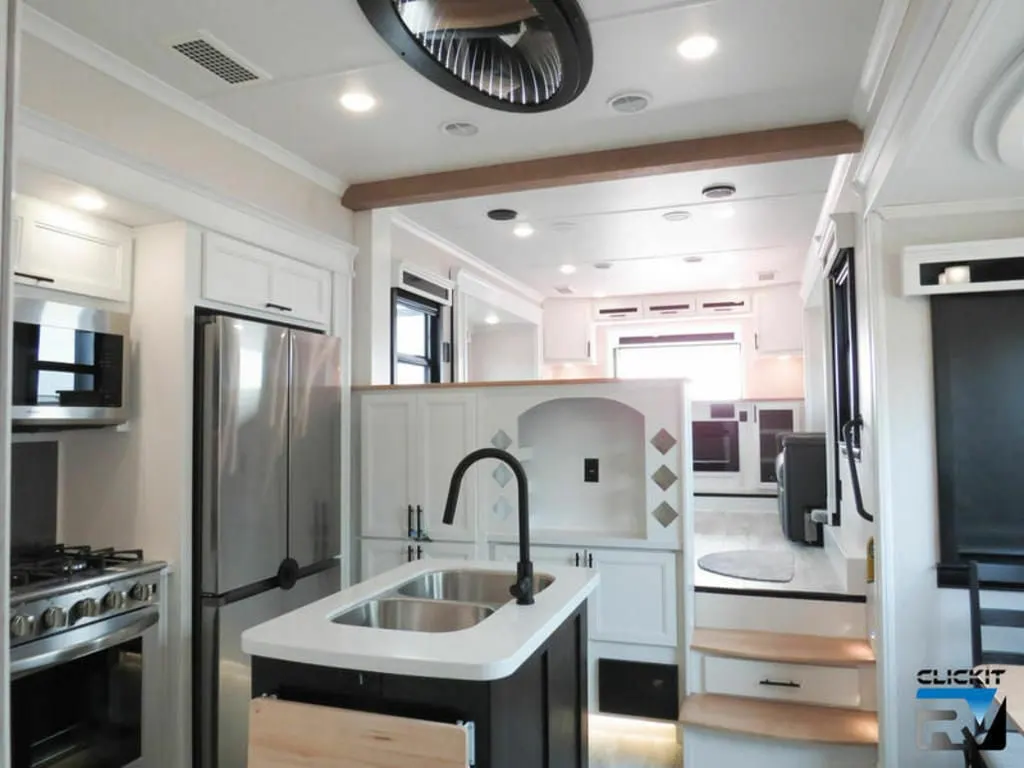 Kitchen with a gas burner, fridge, oven, sink and cabinets.