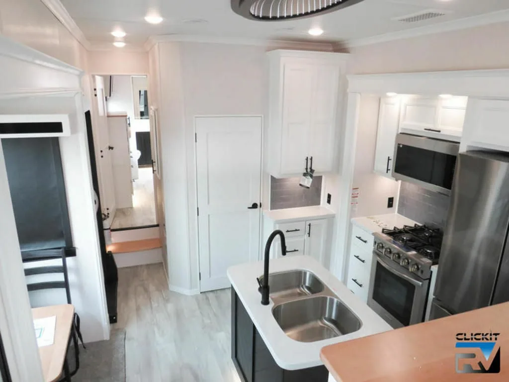 Kitchen with a gas burner, fridge, oven, sink and cabinets.