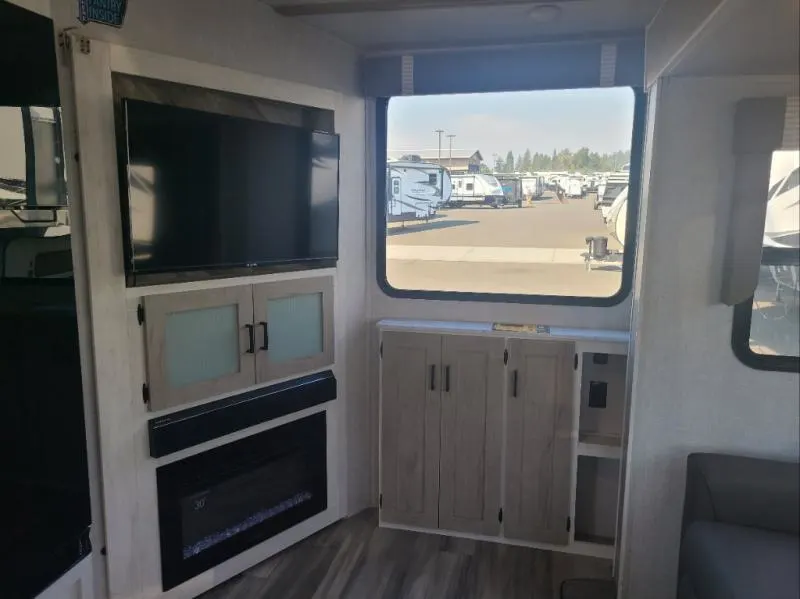 Entertainment center with a TV and a fireplace.