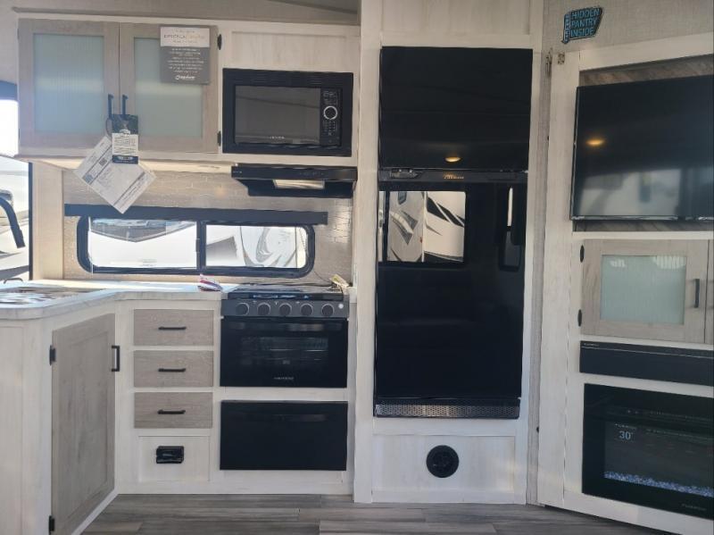 Kitchen with a gas range, fridge, oven, sink and cabinets.