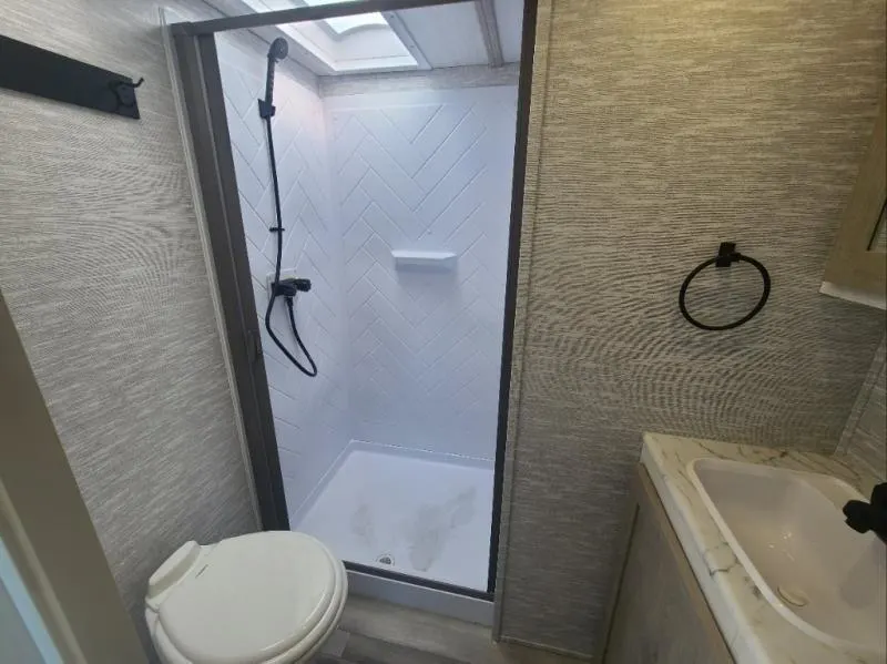 Bathroom with a sink, toilet and a shower.