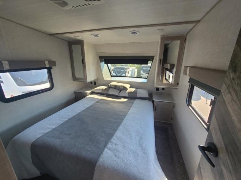 Bedroom with a queen size bed and shirt closets.