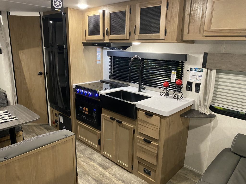 Kitchen with a gas range, fridge, oven, sink and cabinets.