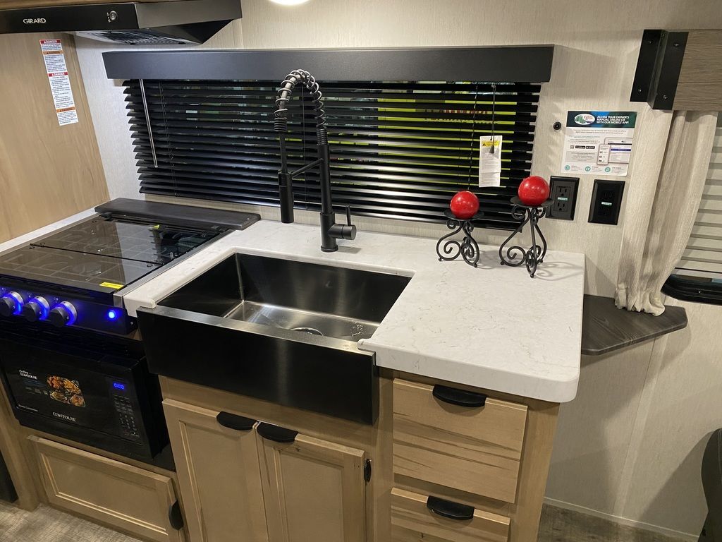 Kitchen with a gas range, sink and cabinets.