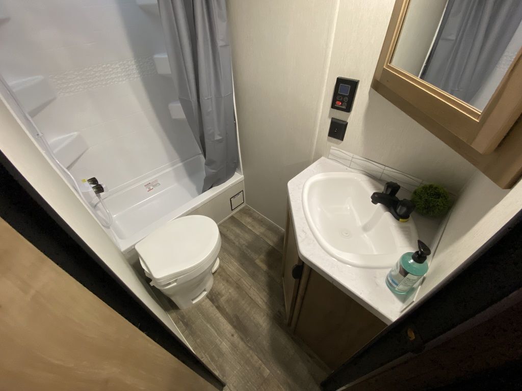 Bathroom with a sink, toilet and a walk-in shower.