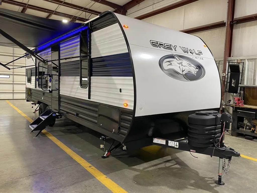 Side view of the New 2024 Forest River Cherokee Grey Wolf 26DJSE Travel Trailer RV.