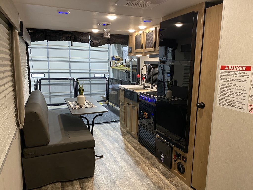 Interior view of the RV with a dinette and a kitchen.