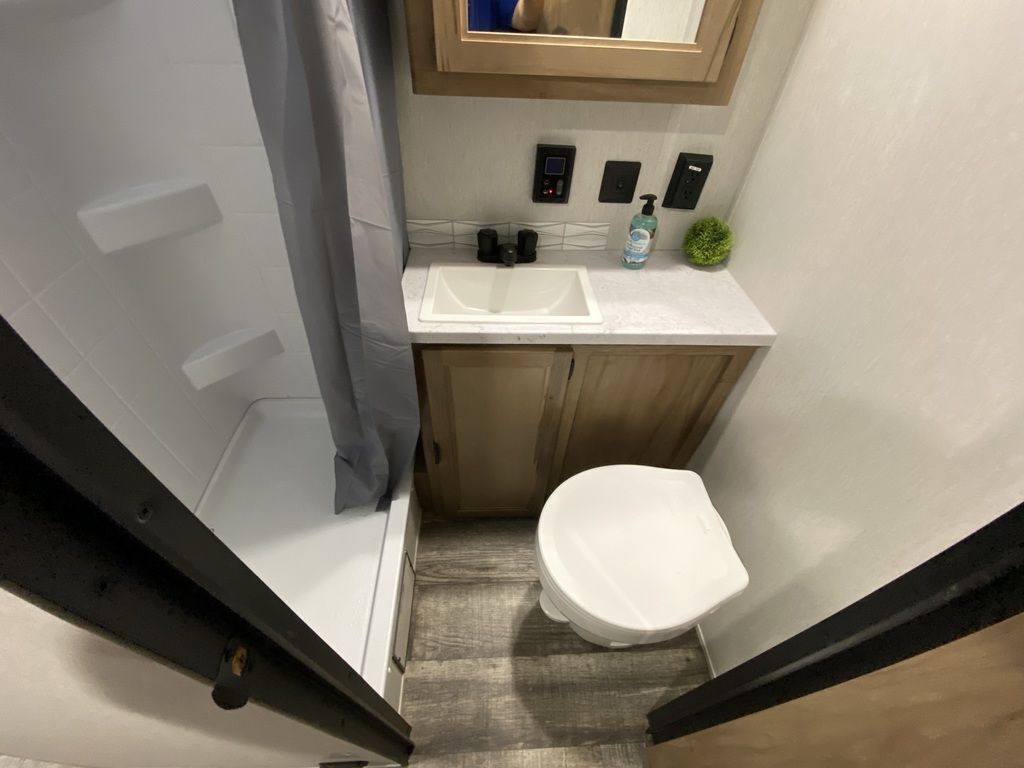 Bathroom with a sink, toilet and a walk-in shower.